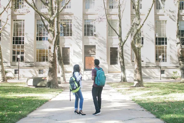 students standing in front of a building