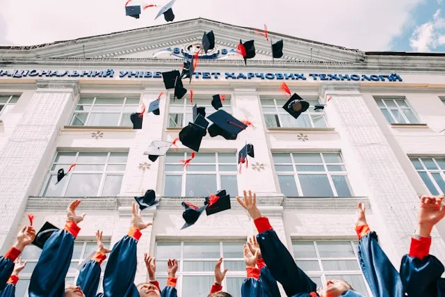 students throwing their graduation hats in the air